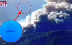 A cigar-shaped UFO suddenly appears during a news report on California’s wildfires