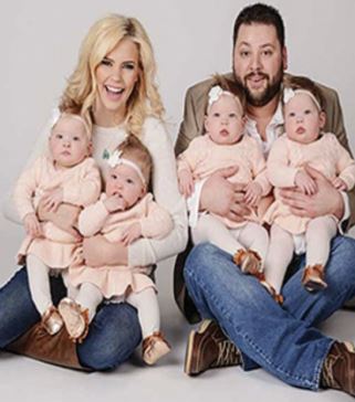 After eight years of waiting, the happy parents take home two sets of identical twin girls.