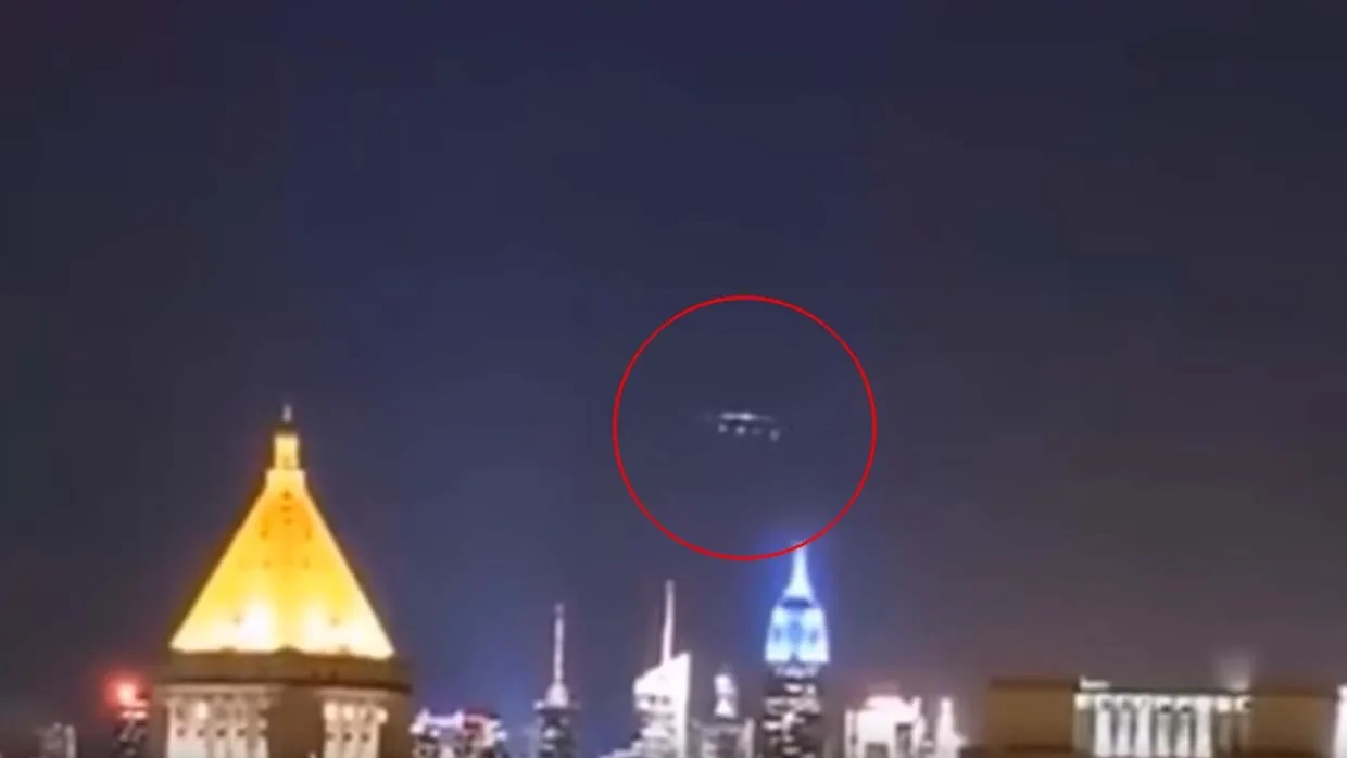 A UFO formation is seen on camera as a mysterious blue light floods New York at night