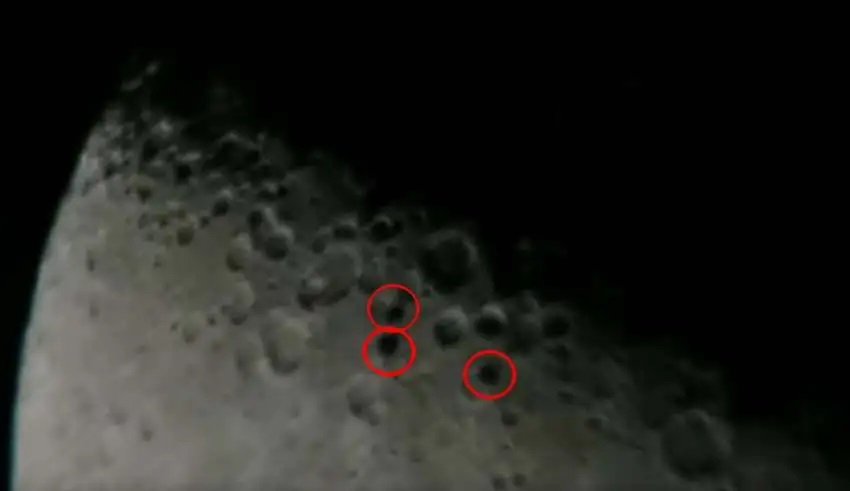 Three disk-shaped UFOs are photographed by an astronomer flying in formation in front of the Moon (UFO on moon)